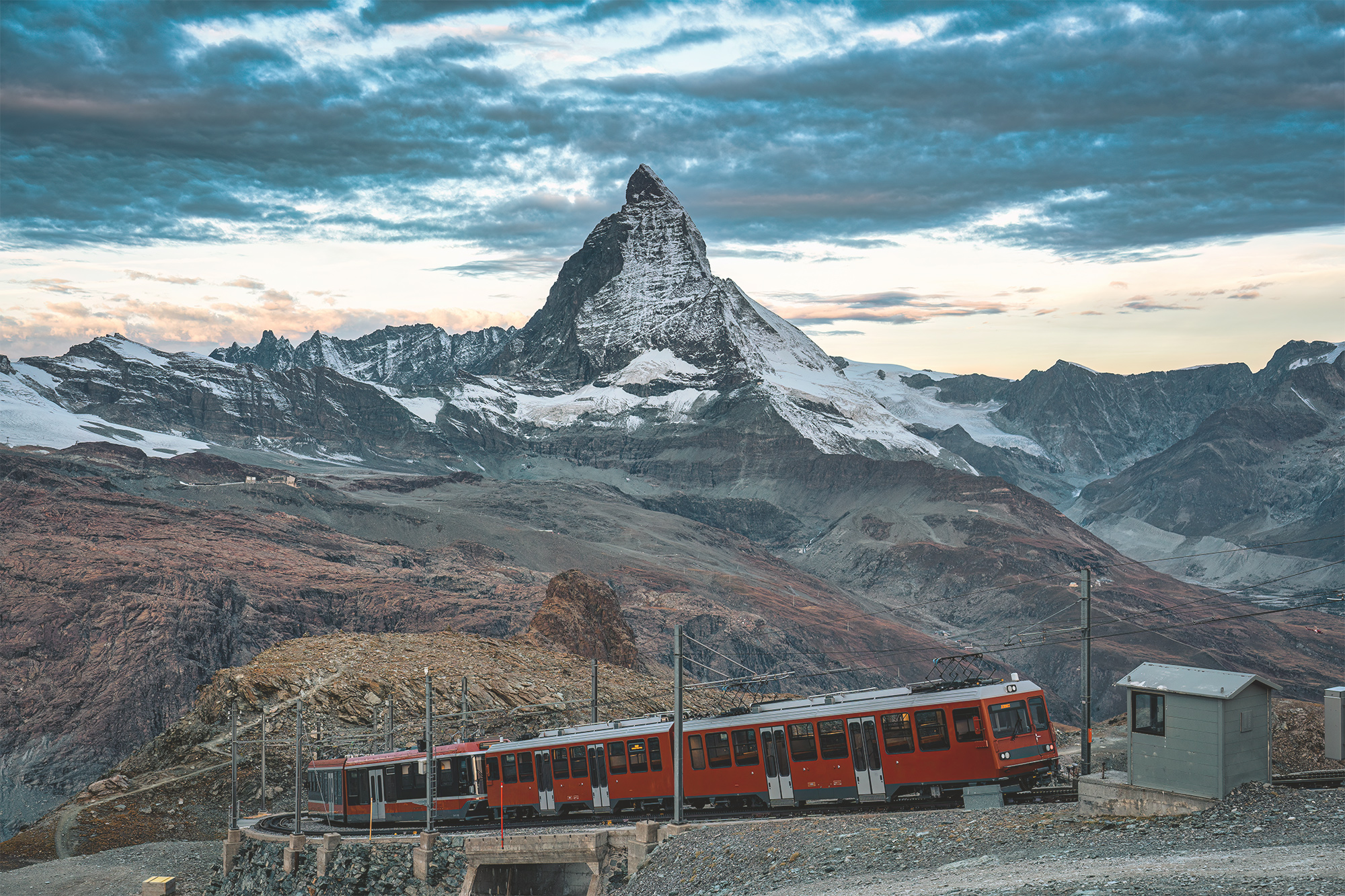 A train running by a mountain in Switzerland